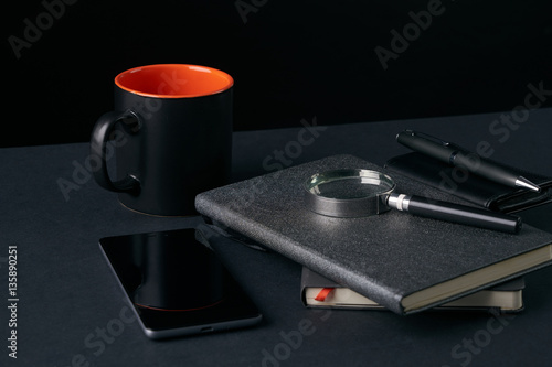 Wallpaper Mural Tea mug, pen, magnifying glass, mobile phone, notebook on table Torontodigital.ca