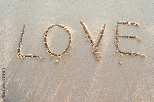 Word LOVE on a sand of beach