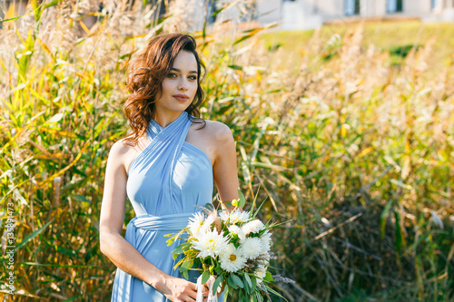 Beautiful young bridesmaid with curly hair