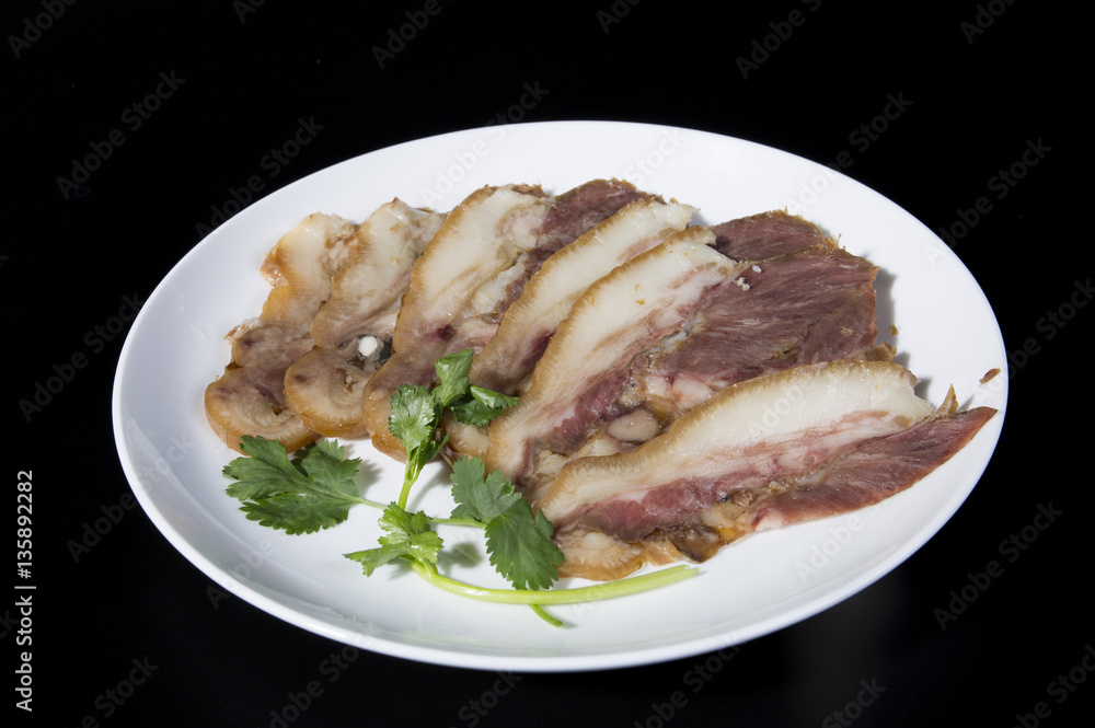Delicious Chinese food, pig`s cheek meat, pieces of meat cut from a pig`s head served as a cold dish to go with drinks, some marinated food in China. Delicious Chinese food, pig`s cheek meat, pieces of meat cut from a pig`s head served as a cold dish to go with drinks, some marinated food in China.