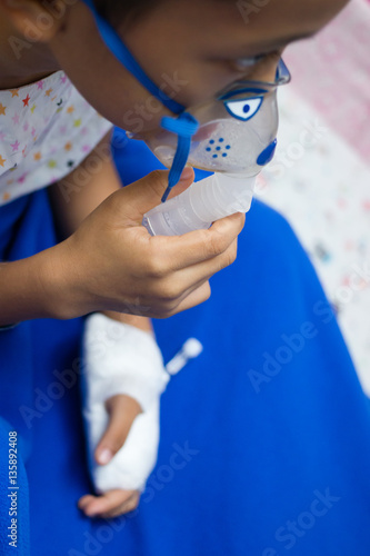 little boy with inhalator mask in hospital