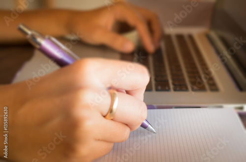 Opened laptop on wooden work table