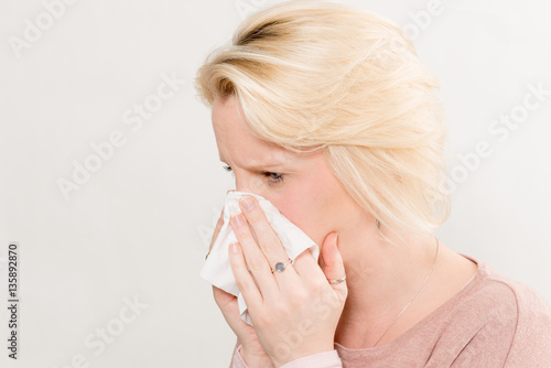 Side View of Woman Pressing Tissue on Nose