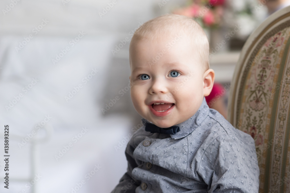 Little boy is sitting on the couch enthusiastically watching his mouth open Little boy is sitting on the couch enthusiastically watching his mouth open