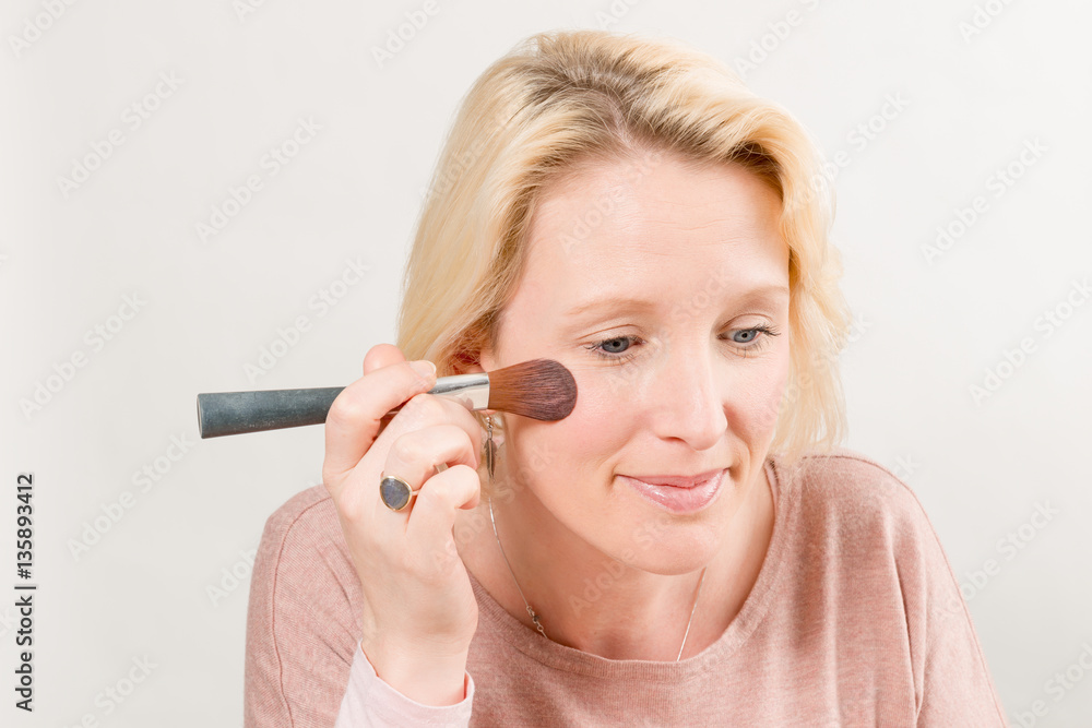 Fototapeta premium Lady Applying Blush with a Brush