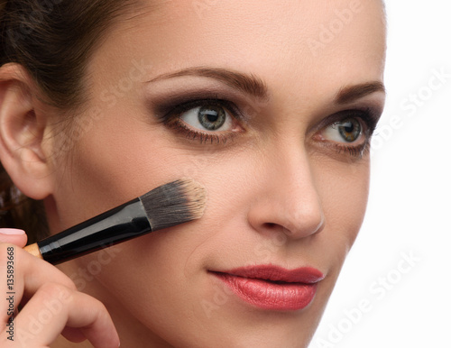 beautiful woman applying make up.