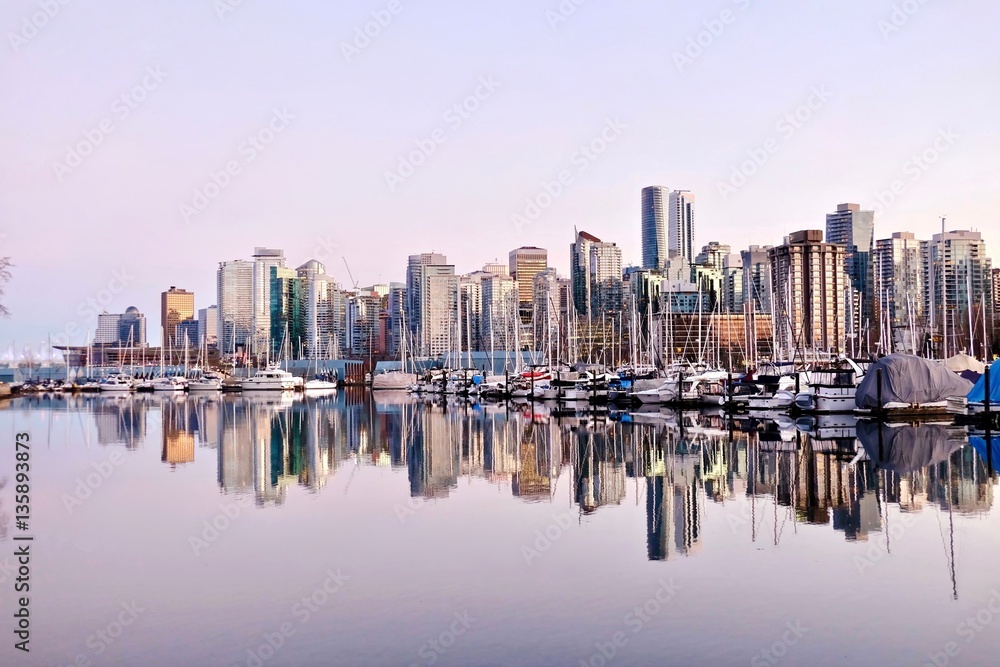 Vancouver skyline and reflection in water. Coal Harbor from Stanley Park. Dowtown Vancouver. British Columbia. Canada.