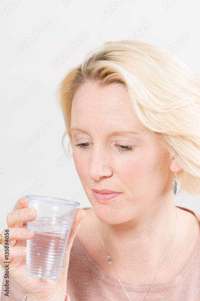 Lady Holding and Looking at Plastic Cup with Water Lady Holding and Looking at Plastic Cup with Water