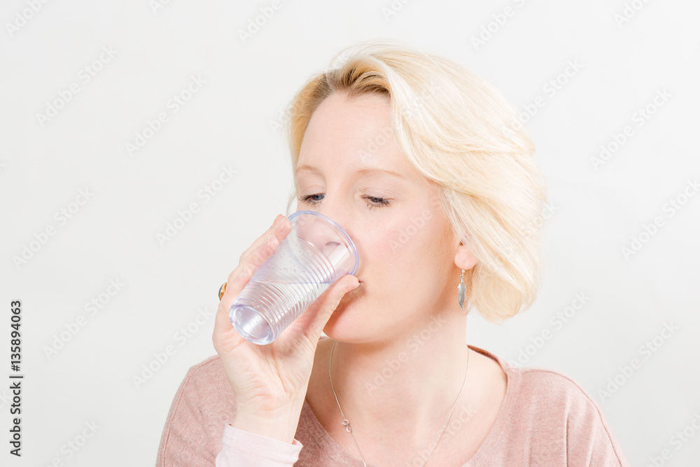 Blonde Woman Over White Background Drinking Water from Plastic C Blonde Woman Over White Background Drinking Water from Plastic C