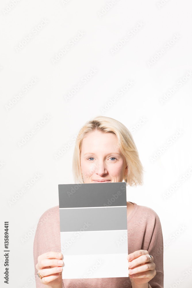 Blonde Woman Holding a Four-Step Gray Scale Card Copy Space Blonde Woman Holding a Four-Step Gray Scale Card Copy Space