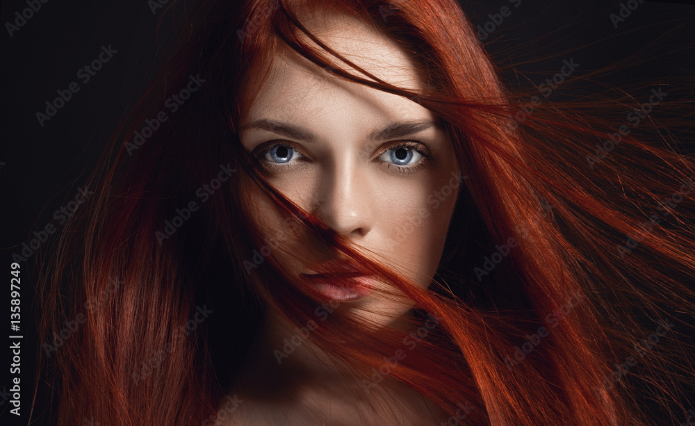 Sexy beautiful redhead girl with long hair. Perfect woman portrait on black  background. Gorgeous hair and deep eyes. Natural beauty, clean skin, facial  care and hair. Strong and thick hair. Flower foto