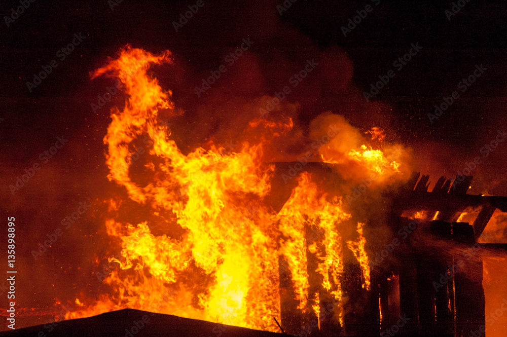 Fototapeta premium Firefighters extinguish a house