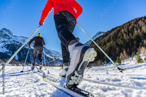 A family group of cross country skiers on a sunny winter morning