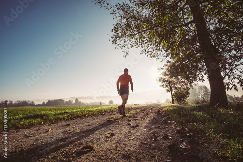 Man running on a path in a forest © Giorgio Pulcini