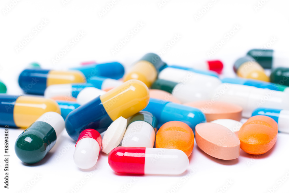 colored pills and capsule on white background colored pills and capsule on white background