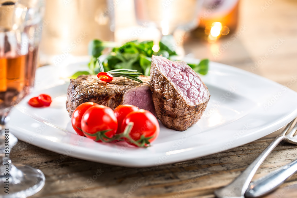 Beef Steak. Juicy beef steak. Gourmet steak with vegetables and glass of rose wine on wooden table. Beef Steak. Juicy beef steak. Gourmet steak with vegetables and glass of rose wine on wooden table.