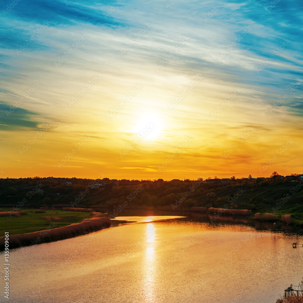 orange sunset in clouds and reflections it in river orange sunset in clouds and reflections it in river