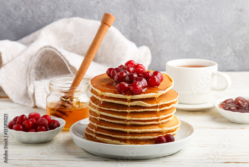 Pancake with honey and fresh berries. Cranberry, cowberry. Gourmet Breakfast. Selective focus