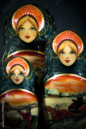 Matryoshka - Pieces of wooden Russian nesting doll isolated on dark background. Still-life picture taken in studio with soft-box.