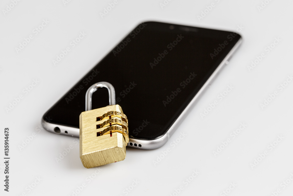 cell phone security - lock and phone on white cell phone security - lock and phone on white