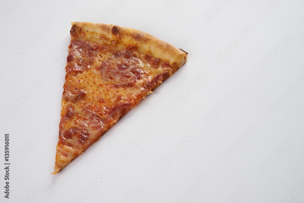 Fototapeta Slice of fresh italian pizza with pepperoni isolated on white background.Copy spase.