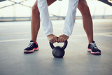 Swing exercise closeup - woman holding kettlebell weight
