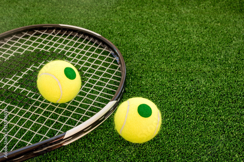 tennis racket on green background © 279photo