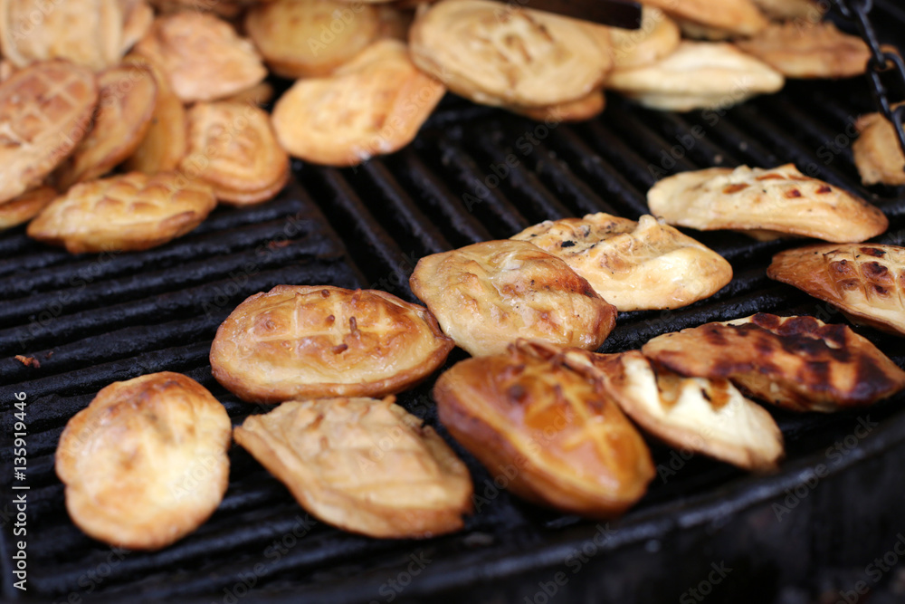 Traditional Polish smoked cheese known as oscypek on barbecue