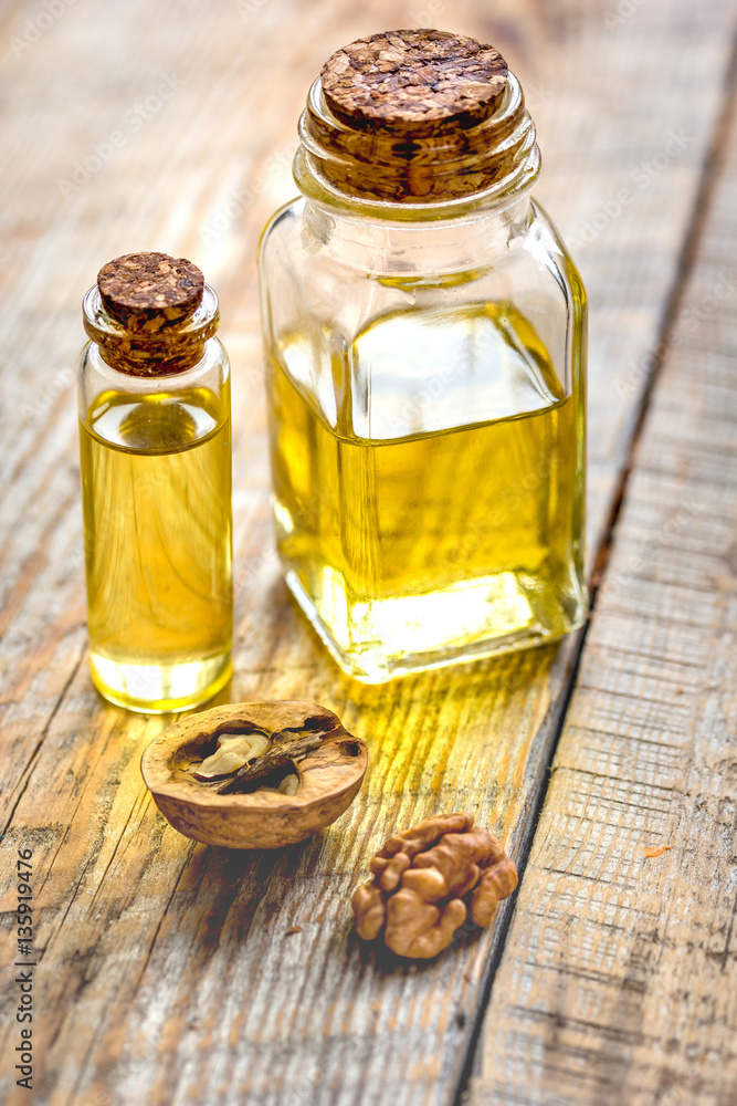 cosmetic and therapeutic walnut oil on wooden background cosmetic and therapeutic walnut oil on wooden background