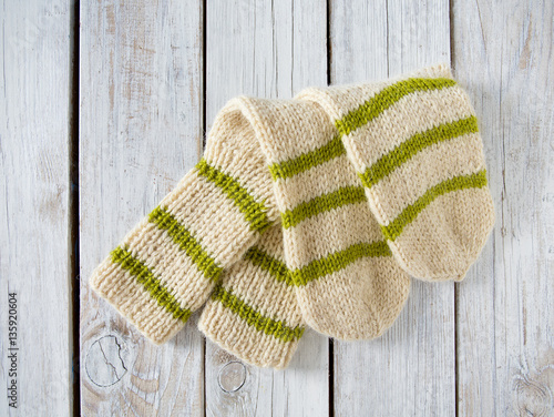 knitted socks on wooden surface photo