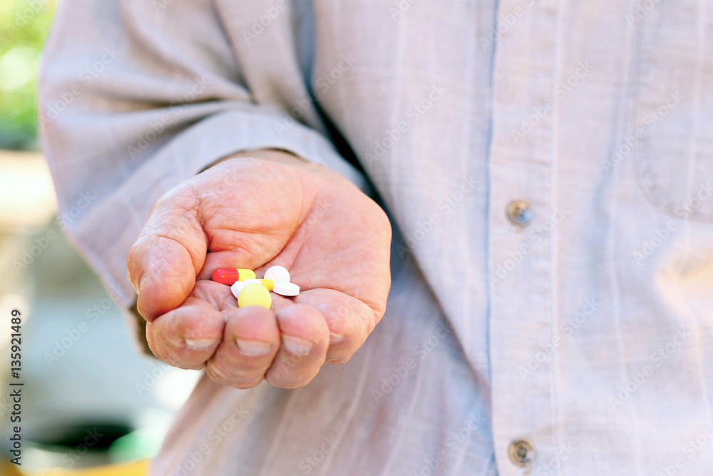 Hand of old senior with pills Hand of old senior with pills