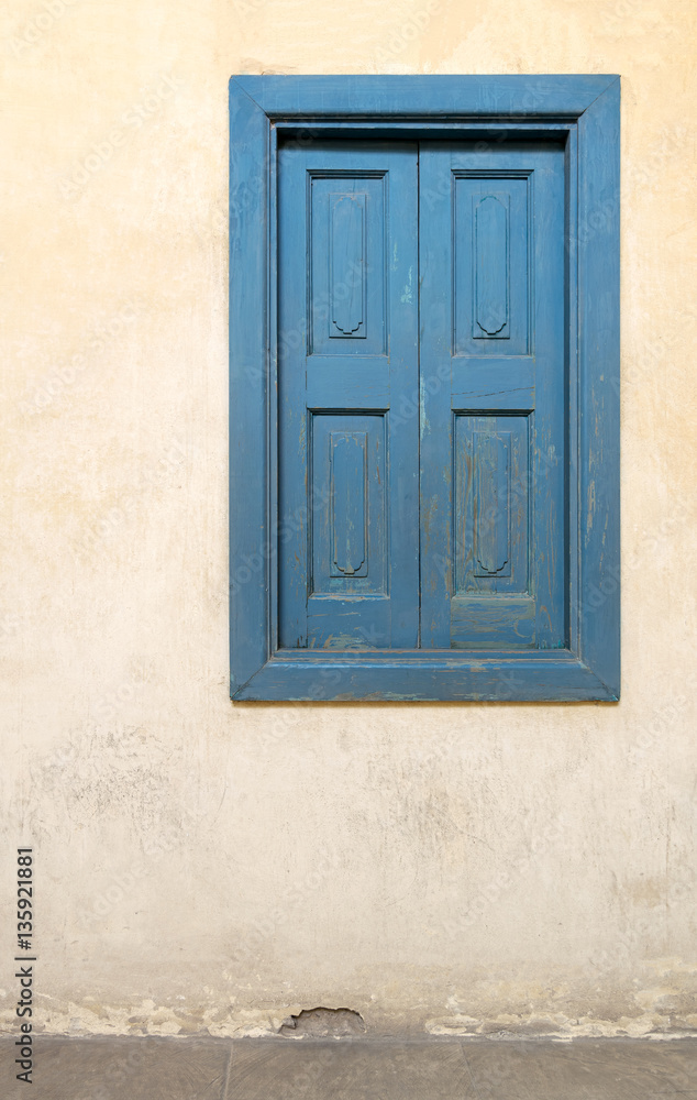 Blue wooden window of a old historic building with vintage plaster wall, Medieval Cairo, Egypt