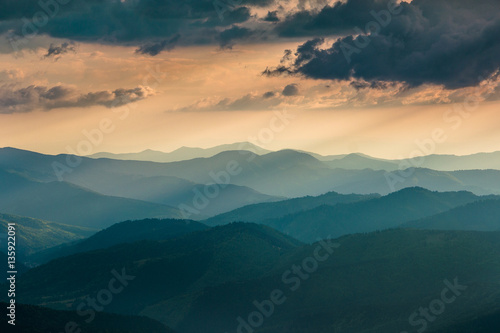 Sunset over layers of mountains.