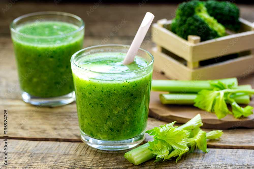Green vegetable smoothie in glass at wooden background Green vegetable smoothie in glass at wooden background