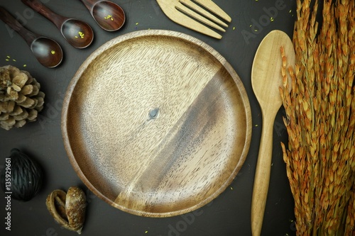 White dish with ear of rice on brown leather background