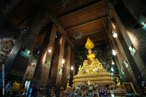 Golden Buddha sitting in Wat Pho Buddhist temple, Bangkok, Thailand. Temple of the Reclining Buddha is a famous landmark built during the first king of Thailand