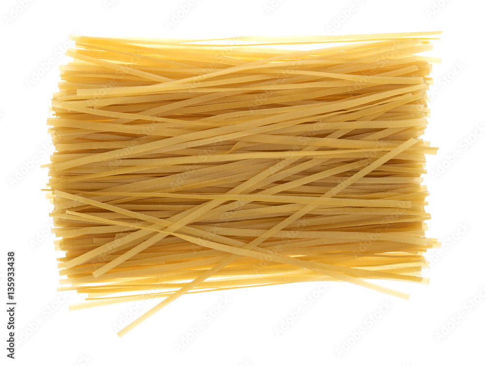 Brown rice pasta fettuccini on a white background top view. Brown rice pasta fettuccini on a white background top view.