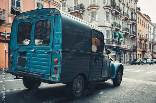 Old wagon car on a city street. Stylish retro photo.