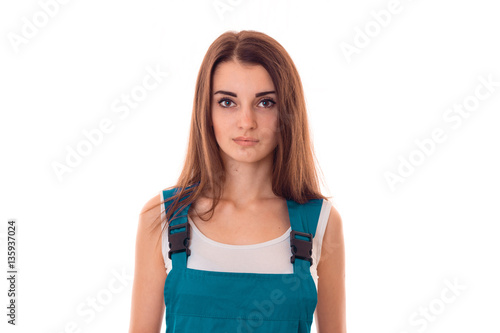 close up of young charming builder girl in uniform makes renovation isolated on white background © ponomarencko