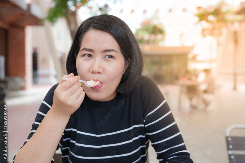 Asian woman eating dessert