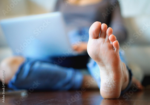 Close up of a young woman's foot relaxed in her apartment 