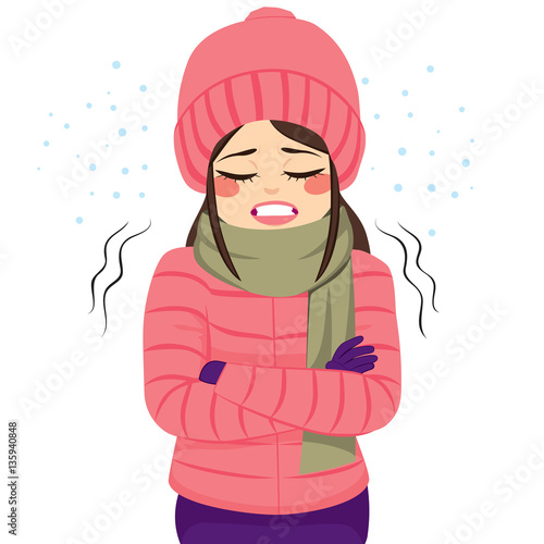 Young woman freezing wearing winter clothes shivering