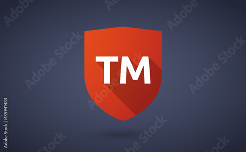 Long shadow shield with    the text TM