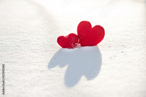 Two red hearts in the snow