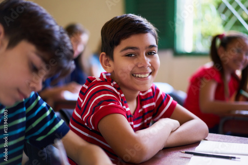 Portrait Of School Boy Looking At Camera In Class