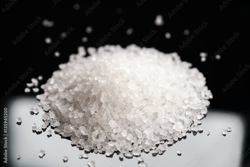 coarse sea salt on black background, shallow focus coarse sea salt on black background, shallow focus