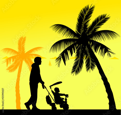 Father walking with his baby on a tricycle on the beach, one in the series of similar images silhouette