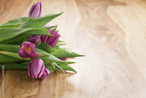 bouquet of purple tulips on wood table with copy space  shallow focus