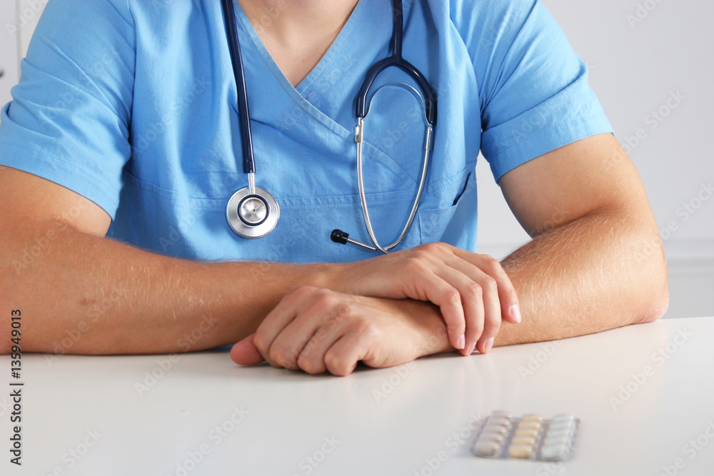 Portrait of a doctor with stethoscope standing isolated on white background Portrait of a doctor with stethoscope standing isolated on white background