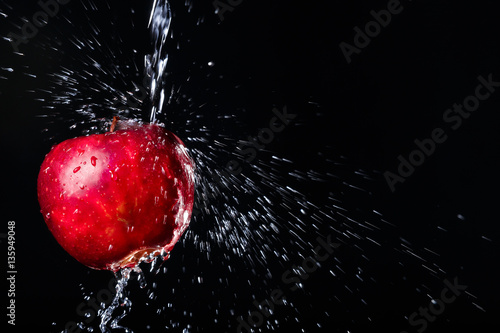 apple in water on black background